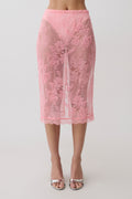 Woman wearing a pink lace midi skirt.