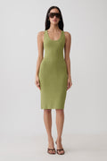 A woman modeling a sleeveless olive green bodycon midi dress with a scoop neckline, paired with dark sunglasses and brown strappy heels, against a plain light gray studio background.