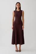 Woman wearing a brown pleated midi dress.