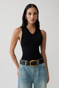 Woman wearing a black knit tank top.