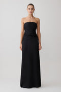 Woman wearing a black strapless gown on a white background