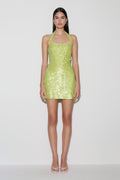 Woman wearing a green sequin halter mini dress.
